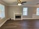 Living room featuring a fireplace, large windows, a ceiling fan, and wood-look flooring at 941 Capitol View Ave, Atlanta, GA 30318