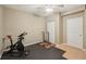 Basement gym with exercise bike and weight rack at 6320 Murets Rd, Alpharetta, GA 30022