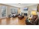 Gathering room with hardwood floors, fireplace, and access to backyard at 6320 Murets Rd, Alpharetta, GA 30022