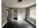 Bedroom featuring dark wood-look floors, a closet, and a window with natural light at 6460 Highway 20 S, Covington, GA 30016