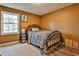 Bedroom with a metal-framed bed, carpeted floors, and a large window at 25 Salem Branch Ct, Covington, GA 30016