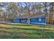 Front yard view of a blue house with trees and landscaping at 25 Salem Branch Ct, Covington, GA 30016