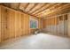 Unfinished basement with exposed framing and a window at 264 Creek View Pl, Canton, GA 30114