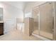 Modern bathroom with tiled shower, soaking tub, and neutral color scheme at 264 Creek View Pl, Canton, GA 30114