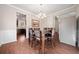 Dining room featuring chandelier, wood table with leather chairs, and wood-look flooring at 264 Creek View Pl, Canton, GA 30114