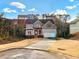 Two-story home with a driveway, front yard, and trees at 264 Creek View Pl, Canton, GA 30114