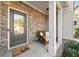 Inviting front porch with brick accents, wicker seating, and a 
