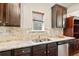 Granite countertops, stainless steel sink, and ample cabinet space in this kitchen at 264 Creek View Pl, Canton, GA 30114