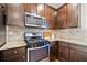 Kitchen features stainless steel appliances, granite countertops, and dark wood cabinets at 264 Creek View Pl, Canton, GA 30114