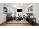 Living room with a fireplace, dark leather furniture, and hardwood floors at 264 Creek View Pl, Canton, GA 30114