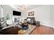 Inviting living room with cozy fireplace, leather furniture, and wood-look flooring at 264 Creek View Pl, Canton, GA 30114