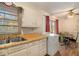 Kitchen with white cabinets and wood laminate counters at 4128 Lindsey Dr, Decatur, GA 30035