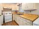 Kitchen with white cabinets and wood laminate counters at 4128 Lindsey Dr, Decatur, GA 30035