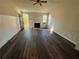 Living room featuring a fireplace, dark wood-look floors, and natural light at 4262 Catalpa Park, Ellenwood, GA 30294