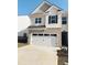 Two-story home with a white garage door and brick facade at 1070 Cades Walk # 180, Lawrenceville, GA 30045