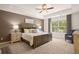 Main bedroom with large window, carpet, and ceiling fan at 1090 Cades Walk, Lawrenceville, GA 30045