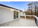 Back deck with white siding, black railing, and sliding glass door at 4130 Seminole Cir, Austell, GA 30106