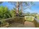 Wooden back deck with stairs and lush green trees surrounding at 1301 S Deshon Rd, Lithonia, GA 30058