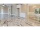 Dining room with marble tile floors, chandelier lighting, and arched openings to the kitchen at 1301 S Deshon Rd, Lithonia, GA 30058