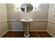 Powder room with pedestal sink and hardwood floor at 1409 Oakridge Cir, Decatur, GA 30033