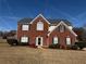 Brick and vinyl two-story home with landscaping and a spacious lawn at 2236 Mission Ridge Se Dr, Conyers, GA 30013