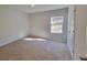 Bright bedroom with neutral walls, carpeting, and large window at 35 Heyman Dr, Covington, GA 30016