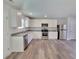 Bright, modern kitchen with stainless steel appliances, granite counters, and white cabinets at 35 Heyman Dr, Covington, GA 30016