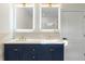 Stylish bathroom with a double vanity, LED mirrors, and blue cabinets at 561 Ashburton Ave, Decatur, GA 30032