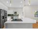 Modern kitchen featuring white cabinets, stainless steel appliances, and an island with quartz countertop at 561 Ashburton Ave, Decatur, GA 30032