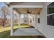 Covered back patio with ceiling fan and views of neighboring homes at 1495 Auburn Glen Rd, Dacula, GA 30019