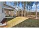 Covered back patio with a ceiling fan and wooded backyard at 1495 Auburn Glen Rd, Dacula, GA 30019