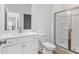 Clean bathroom featuring white vanity, toilet, and a glass shower at 1495 Auburn Glen Rd, Dacula, GA 30019