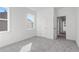 Empty bedroom with gray carpet, white walls, and two windows at 1495 Auburn Glen Rd, Dacula, GA 30019