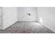 Empty bedroom with gray carpeting and window at 1495 Auburn Glen Rd, Dacula, GA 30019