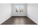 Simple bedroom with wood-look flooring and abundant natural light at 1495 Auburn Glen Rd, Dacula, GA 30019