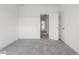 Empty bedroom with gray carpet and white walls at 1495 Auburn Glen Rd, Dacula, GA 30019