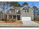 Inviting two-story home with a charming front porch and a two-car garage at 1495 Auburn Glen Rd, Dacula, GA 30019