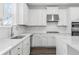 Modern kitchen featuring white cabinets, stainless steel appliances, and white countertops at 1495 Auburn Glen Rd, Dacula, GA 30019