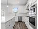 Modern kitchen with white cabinets, stainless steel appliances, and large island at 1495 Auburn Glen Rd, Dacula, GA 30019