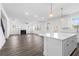 Kitchen island overlooking the living room with a fireplace and ceiling fan at 1495 Auburn Glen Rd, Dacula, GA 30019