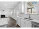View of the kitchen sink, dishwasher, and open living room in background at 1495 Auburn Glen Rd, Dacula, GA 30019