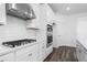 Kitchen with white cabinetry, stainless steel appliances, and a gas cooktop at 1495 Auburn Glen Rd, Dacula, GA 30019