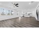 Open-concept living area with wood-look floors and adjacent kitchen at 1495 Auburn Glen Rd, Dacula, GA 30019