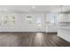 Open living area with wood floors and access to a kitchen at 1495 Auburn Glen Rd, Dacula, GA 30019