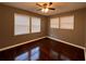 Bedroom with dark wood floors, multiple windows, and a ceiling fan at 1947 Kenwood Pl, Smyrna, GA 30082