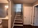 Stairway with dark wood treads and white risers, viewed from the entryway at 1947 Kenwood Pl, Smyrna, GA 30082