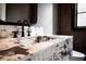 Close-up of a modern bathroom vanity with marble countertop and black fixtures at 3790 Ivy Ne Rd, Atlanta, GA 30342