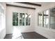 Dining room featuring wood beams, a modern chandelier, and windows offering views of the outdoors at 3790 Ivy Ne Rd, Atlanta, GA 30342