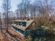 Long blue house with barn doors, deck, and surrounding trees at 772 Old Lathemtown And 776 Rd, Canton, GA 30115
