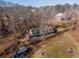 Blue house with shed, in a wooded area with another house visible at 772 Old Lathemtown And 776 Rd, Canton, GA 30115